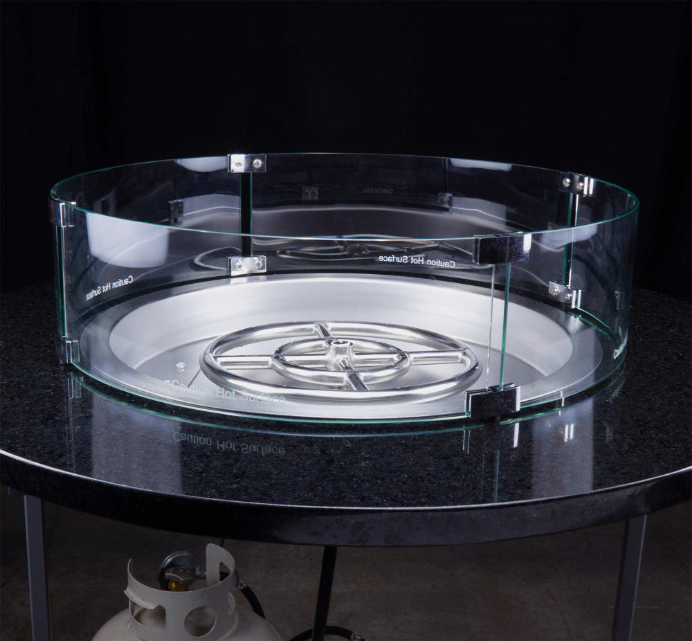 A 19" round propane fire pit burner pan in a granite table top with a 23" round flame guard around it.