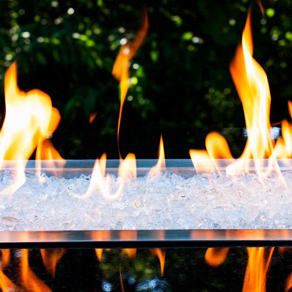 Horizontal view of a glistening crystalline fire pit with tempered fire glass rocks